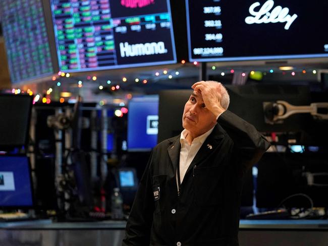 A trader reacts on the floor of the New York Stock Exchange at the closing bell on December 30, 2022 in New York. (Photo by TIMOTHY A. CLARY / AFP)