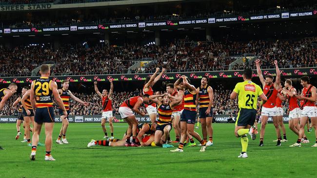 ADELAIDE, AUSTRALIA - APRIL 19: The Crows react as The Bombers celebrate their win during the 2024 AFL Round 06 match between the Adelaide Crows and the Essendon Bombers at Adelaide Oval on April 19, 2024 in Adelaide, Australia. (Photo by James Elsby/AFL Photos via Getty Images)