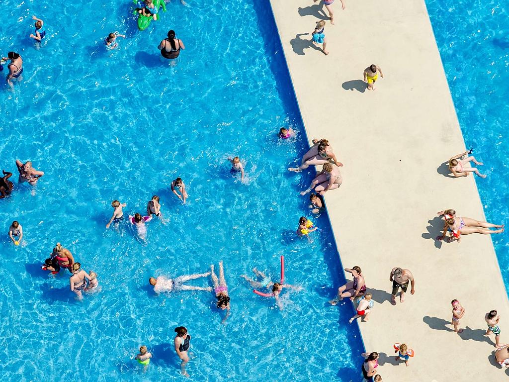 An aerial view shows sunbathers in a pool in Hazerswoude, the Netherlands, on July 1, 2015, on a warm summer day. Picture: AFP