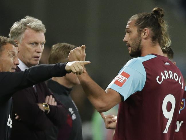 Andy Carroll, right, talks to West Ham United's David Moyes, second left.