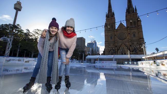 Avalon, 11, and Lotus van der Starre, 13, at the Air Canada rink at the Skating At Sydney Festival 2019, on the forecourt of St Mary's Cathedral. Picture: Justin Lloyd