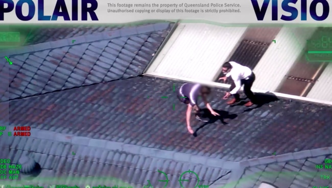 The man being arrested on a roof in Caboolture by police on January 11.