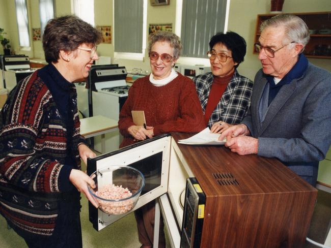 Barbara Rogers teaching a microwave cooking class Pauline Kent, Miranda Koh and Geoff Innes in 1994.