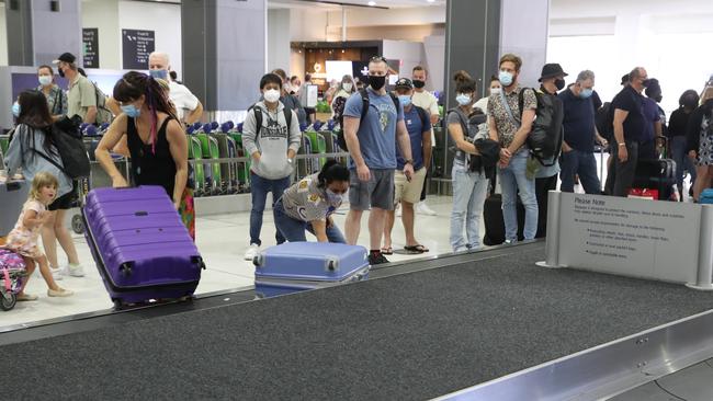 People arrive at Melbourne Airport from their Brisbane flights. Picture: David Crosling