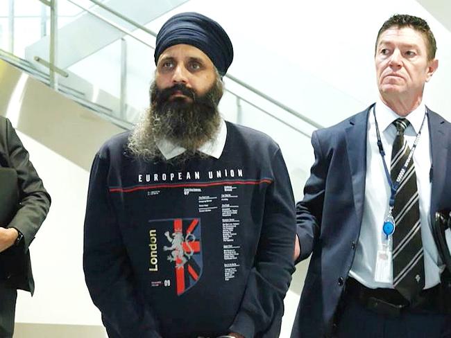 Rajwinder Singh (middle, wearing a turban) arrives in Melbourne after being extradited from India in relation to the death of Toyah Cordingley. Picture: Queensland Police Service