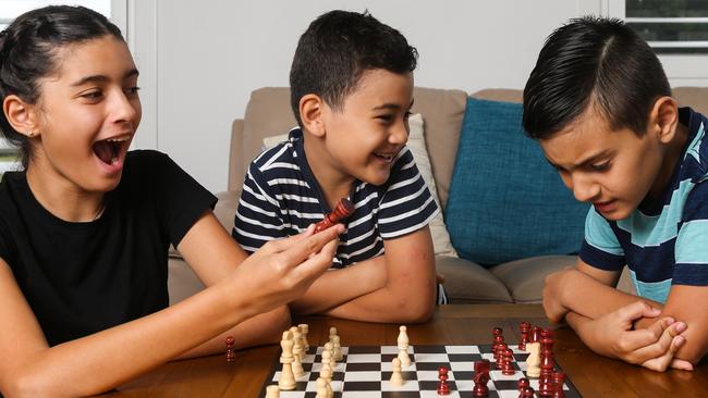 Isabela Micallef, Oliver Micallef and Joshua Micallef, play chess at home in Sydney. Picture: Newscorp Daily Telegraph / Gaye Gerard