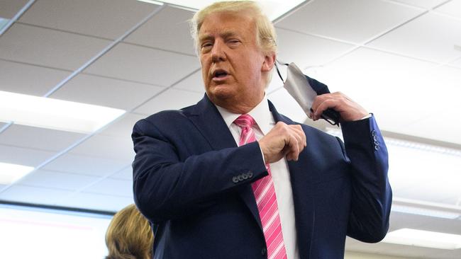 US President Donald Trump takes off his mask before speaking to media. His rival Joe Biden says comments Trump’s chief of staff reveal Trump has hung up his mask on controlling the coronavirus pandemic. Picture: Mandel Ngan/AFP