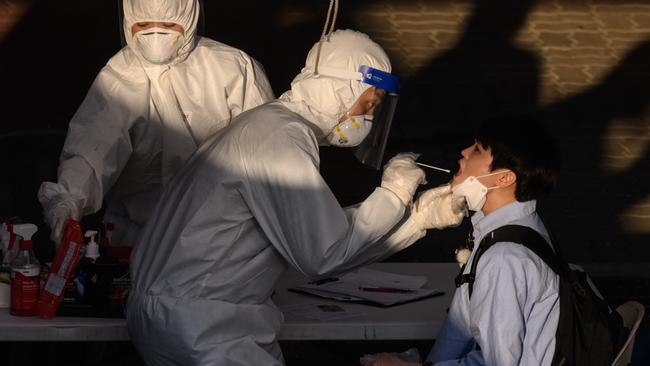 A health worker administers a swab at a temporary COVID-19 novel coronavirus testing centre in Bucheon, south of Seoul. Picture: AFP