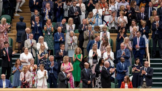 University of Oxford Professor Sarah Gilbert (seated in red, bottom right) one of the scientists behind the AstraZeneca vaccine, receives a spontaneous standing ovation at Wimbledon. Picture: AELTC/Joe Toth-Pool/Getty Images