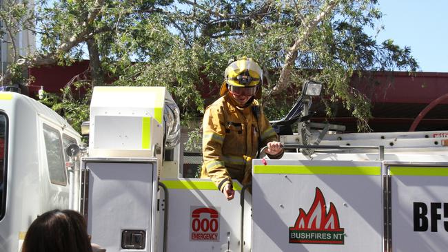 A volunteer firefighters throws lollies to the kids. Picture: Gera Kazakov