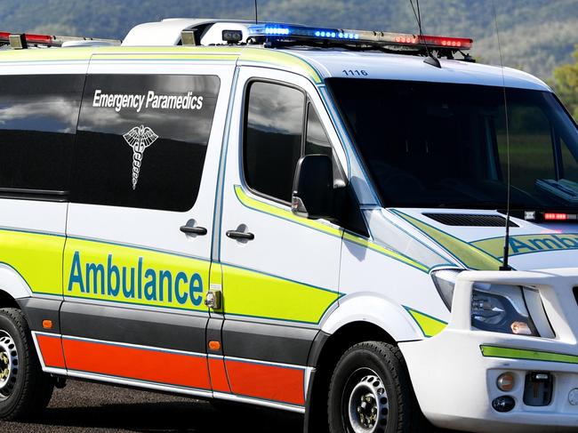 Emergency services attend a fatal car crash on the Bruce Highway, south of Townsville at Mount Surround. Garbage truck driver being looked over by paramedics.  Picture: Alix Sweeney