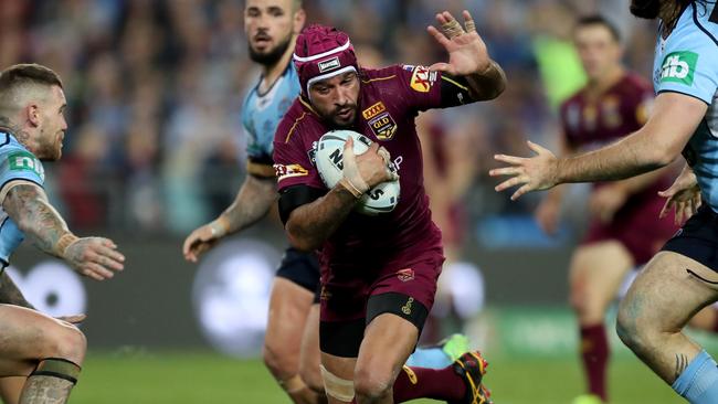 Johnathan Thurston attempts to bust the tackle of Josh Dugan and Aaron Woods. Picture: Brett Costello