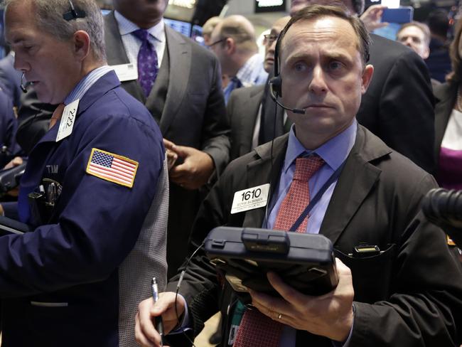Trader George Baskinger, center, works on the floor of the New York Stock Exchange Thursday, May 21, 2015. U.S. stocks edged higher in early trading. Energy stocks rose more than the rest of the market as the price of oil climbed. (AP Photo/Richard Drew)