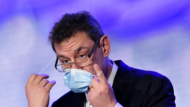 Pfizer CEO Albert Bourla adjusts his face mask during a press conference after a visit to oversee the production of the Pfizer-BioNtech vaccine.