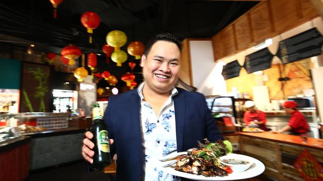 Lantern Lane is a new food destination off the Stockland Cairns food court, offering the tastes of Asia. Lantern Lane CEO Jay Le enjoys an Asian dish with a cold Chang beer. PICTURE: BRENDAN RADKE