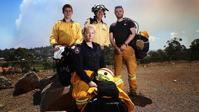 (L-R) Tim Colefax from NSW Rural Fire Service, Jess Playford ACT Rural Fire Service, Colin Fitzgibbon, NSW Rural Fire Service and Daniel Bowran from ACT Rural Fire Service awaiting deployment as a remote are firefighting team at the community centre in Miena. Picture: LUKE BOWDEN