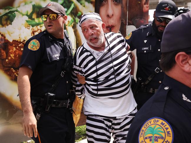 Dominic Santana is taken into custody outside of the Wilkie D. Ferguson Jr. federal courthouse following an incident that occurred when the motorcade carrying former President Donald Trump departed the courthouse in Miami, Florida.