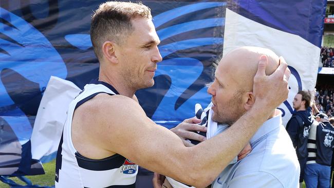 Joel Selwood hugs Gary Ablett Jr after carring Levi Ablett onto the MCG. Picture: Michael Klein