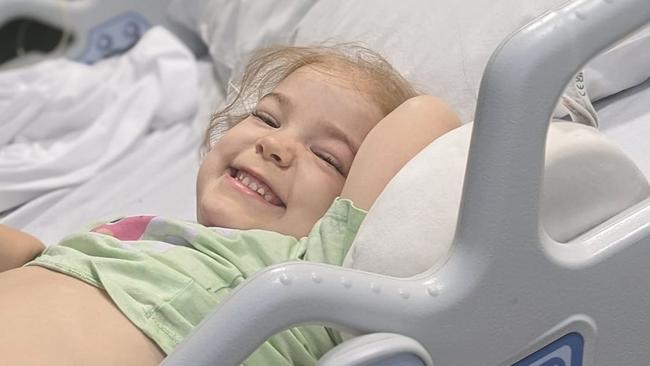 Tessa Perry was all smiles in hospital despite her daily needles. Picture – contributed.