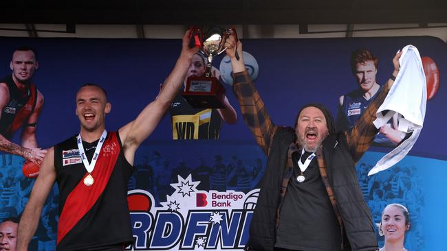 Riddell captain Josh Grabham and coach Justin Belleville lift the premiership cup. Picture: Hamish Blair