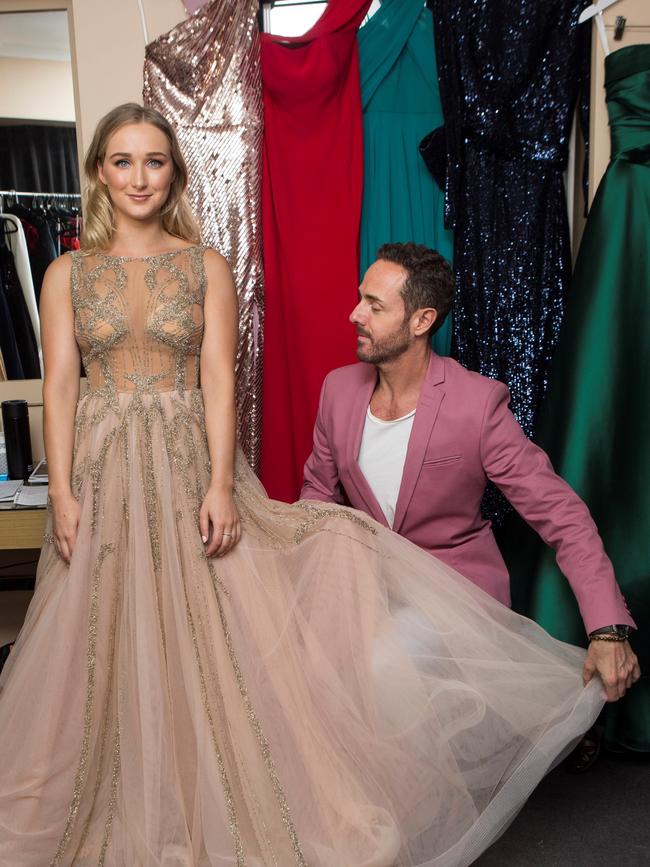 Jesse Arena tries on dresses with Donny Galella.