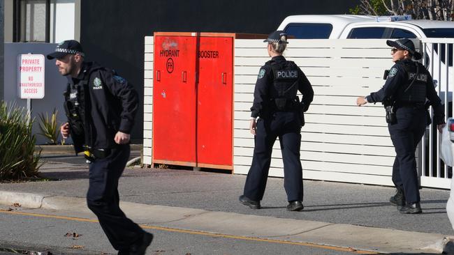 Detectives outside the block of flats. Picture: Dean Martin