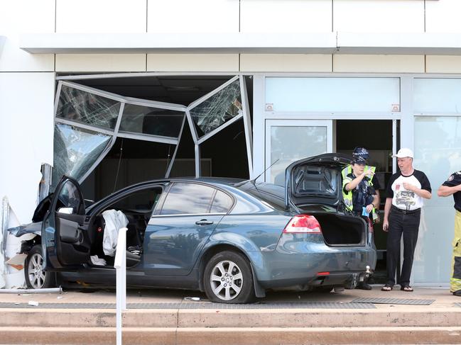 Single MVA where a car left the road on Gold Coast Highway Labrador, took out a street light pole, travelled a further 300 metres before crossing Babbidge Street and smashing into the Aussie Homeloans office. One male was transferred to Gold Coast University Hospital. The man in white shirt is Aussie Homeloans worker but wouldn't speak to media. Picture: Richard Gosling