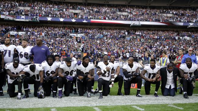 Baltimore Ravens players kneel during the US national anthem at Wembley Stadium in London, Picture: AP