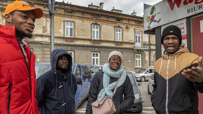 Nigerian students Simeon Gbenga (far right) and Bridget (second from right) with their friends at Przemysl Glowny Station, Poland. Picture: Annabel Moeller