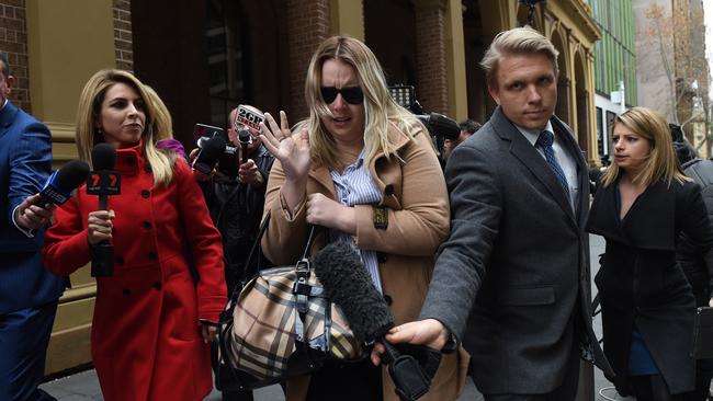 Jessica McNamara, centre, daughter of Glen McNamara, leaves the NSW Supreme Court today.