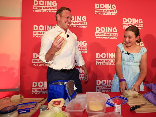 Premier Steven Miles makes a sandwich with his daughter Bridie, 10, on stage at the Labor party’s campaign launch on Sunday. Picture: Adam Head