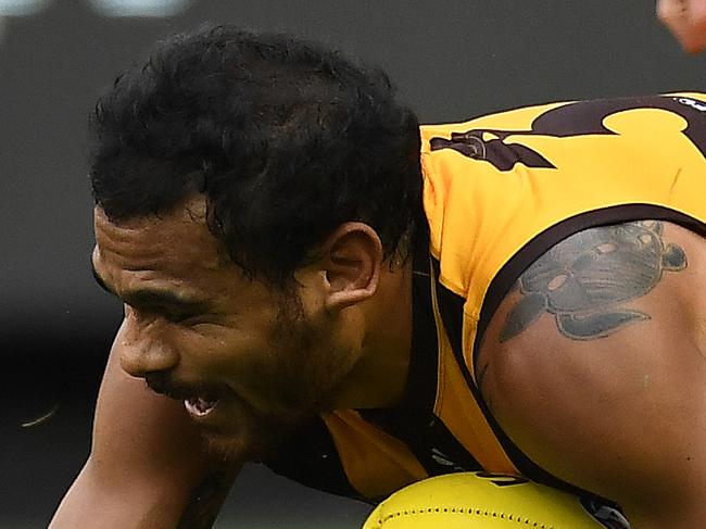 Cyril Rioli of the Hawks (right) is seen as he sustains an injury during the Round 4 AFL match between the Hawthorn Hawks and the Melbourne Demons at the MCG in Melbourne, Sunday, April 15, 2018. (AAP Image/Julian Smith) NO ARCHIVING, EDITORIAL USE ONLY