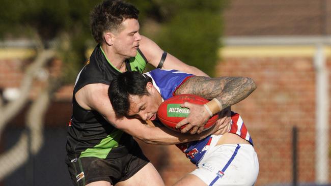 SFNL: Doveton’s Cameron Williamson wraps up Mark Di Blasio of Keysborough. Picture: Valeriu Campan