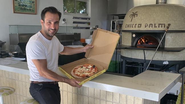 Chicco Palms co-owner Peter De Marco at the Brooklyn Park restaurant with one of their winning pizzas. Pic: PAULA THOMPSON