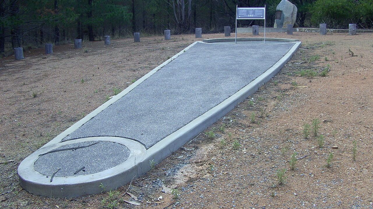 <p>What you are looking at above is the Canberra Air Disaster memorial. It depicts a plane's wing, thank you very much. The memorial <span>marks the location of a plane crash in 1940 that killed ten people.</span></p><p>Thirty years later, in May of 1971, a walker stumbled upon the remains of a young woman near the site.</p><p>Twenty-year-old Keren Rowland had been murdered 15 metres from the track three months prior. It remains a cold case. Police recently picked it up again in December 2020.</p><p>It is considered to be another highly haunted spot.</p><p><span>According to <a href="https://the-riotact.com/the-air-disaster-memorial-has-a-dark-history-with-vehicles/427400">Riotact</a>, since the 1970s, reports abound of mysterious noises and figures, but also things happening to cars &ndash; stalling, failing to start, radios flicking on and off, lights going out, and moving while in &lsquo;park&rsquo; with the handbrake on.</span></p><p><span>One teenager fled the forest screaming, claiming she was being followed by images of an airman on fire.</span></p><p><span>A poll of the Queanbeyan Community Notice Board on Facebook reveals that about 25 per cent of respondents experienced something chilling involving them or their car while visiting the memorial.</span></p>