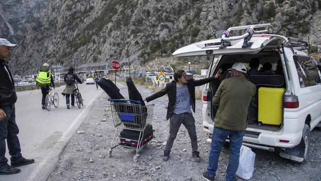 Russians heading towards Tbilisi pack belongings into a car after crossing Verkhni Lars customs checkpoint on Wednesday in Georgia. Picture: Getty Images