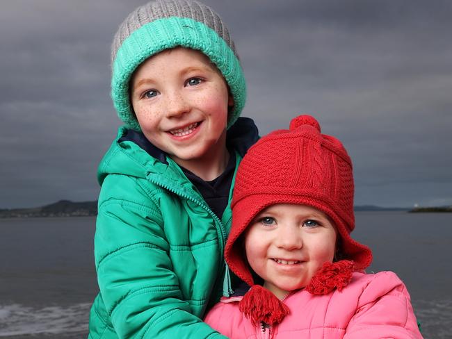 Siblings Elias, 5 and Rainier Tomlin, 2 of Mount Rumney are dressed in their puffy jackets as they enjoy the cold weather at Long Beach, Sandy Bay.  Picture: Zak Simmonds