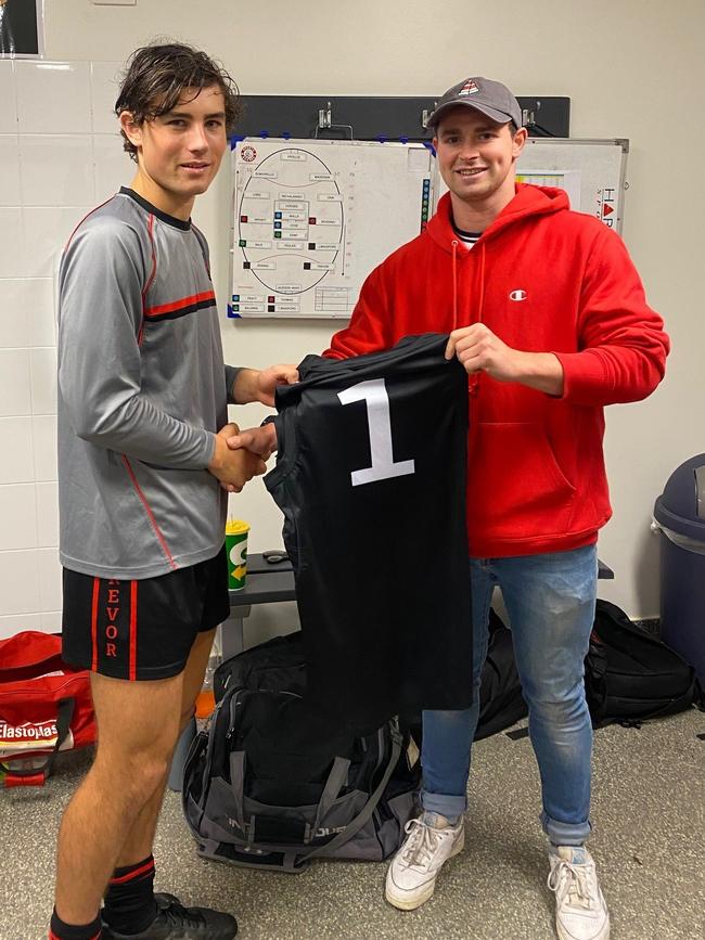 Rostrevor First XVIII football captain Jayden Gale (L) presented with his guernsey by 2016 Head Prefect, First XVIII skipper, and 2019 Glenelg premiership player, Brad McCarthy. Supplied, Rostrevor College