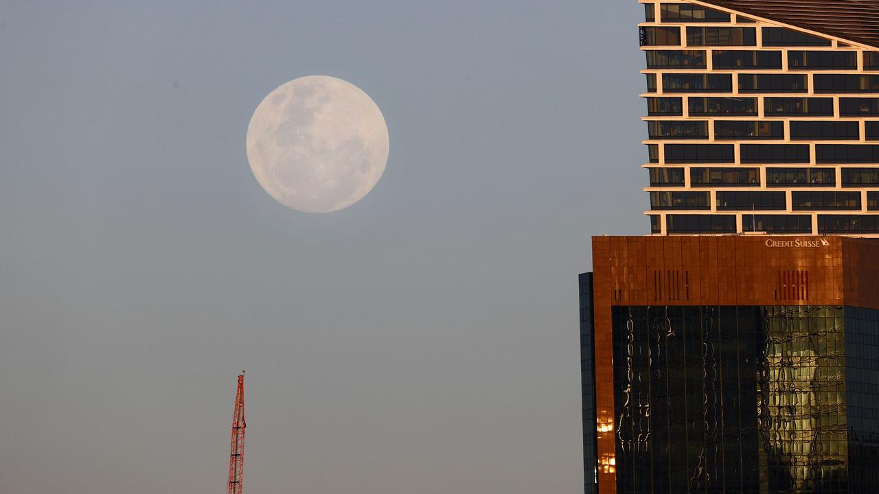 A regular full moon rising over the Sydney skyline. Picture: Richard Dobson