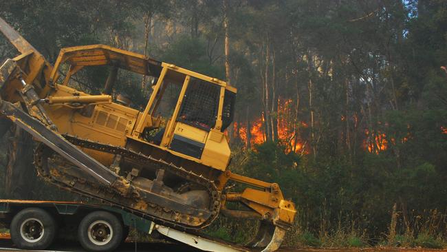 Bulldozer creating fire break. Bushfire in Gippsland.