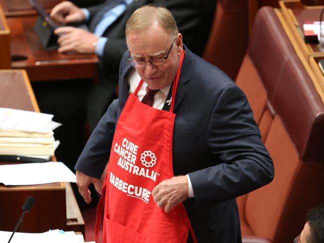Senator Ian Macdonald during Senate Question Time and still wearing his Cancer Australia BBQ apron. Picture Gary Ramage