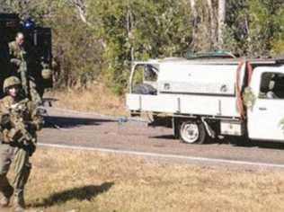 Tactical response officers from the Northern Territory Police Force with the abandoned vehicle of Jonathon Andrew Stenberg who is the prime suspect in the murder of Broadwater man, Edward 'Ned' Kelly who's decapitated body was found in his home last week. Photo: Northern Territory Police Force. Picture: NT Police