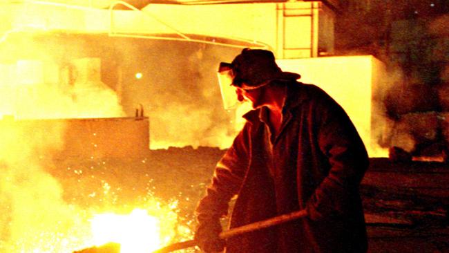 A worker checks the quality of steel in a blast furnace at a Severstal steel mill in Russia. Picture: Alexei Boitsov/ Bloomberg News