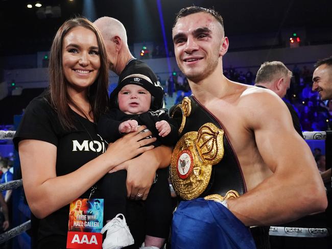 Andrew Moloney celebrates his win against Elton Dharry with wife Chelsea and son Lee. (AAP Image/Michael Dodge)