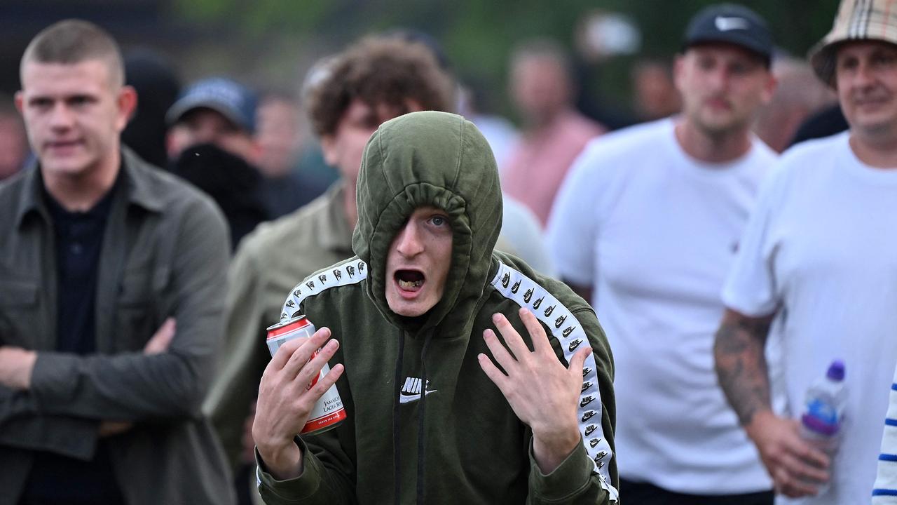 A protester gestures at riot police during one clash. (Photo by JUSTIN TALLIS / AFP)