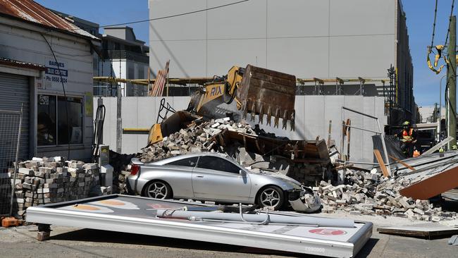 Excavators from the Doulos apartments building site were used to pull down the remaining building. Picture: AAP