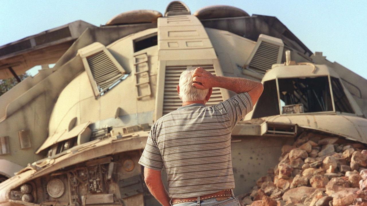 A confused tourist looks at one of the spacecraft props from the movie Pitch Black, which is now part of a property sale at Coober Pedy, SA. Picture: