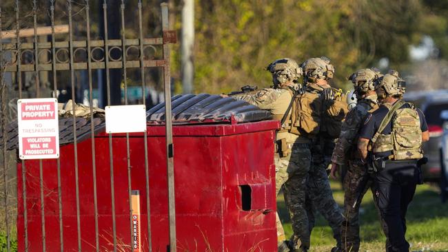 Law enforcement officers approach a location in Houston, Texas, Wednesday, Jan. 1, 2025, where police personnel investigate the place suspected to be associated with attackers in a deadly rampage in New Orleans. (Brett Coomer/Houston Chronicle via AP)