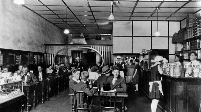 This photograph of the Busy Bee Cafe in Kingaroy was taken on this day (January 2) in 1929. Owner George Trifilis is standing behind the counter. Picture: State Library of Queensland