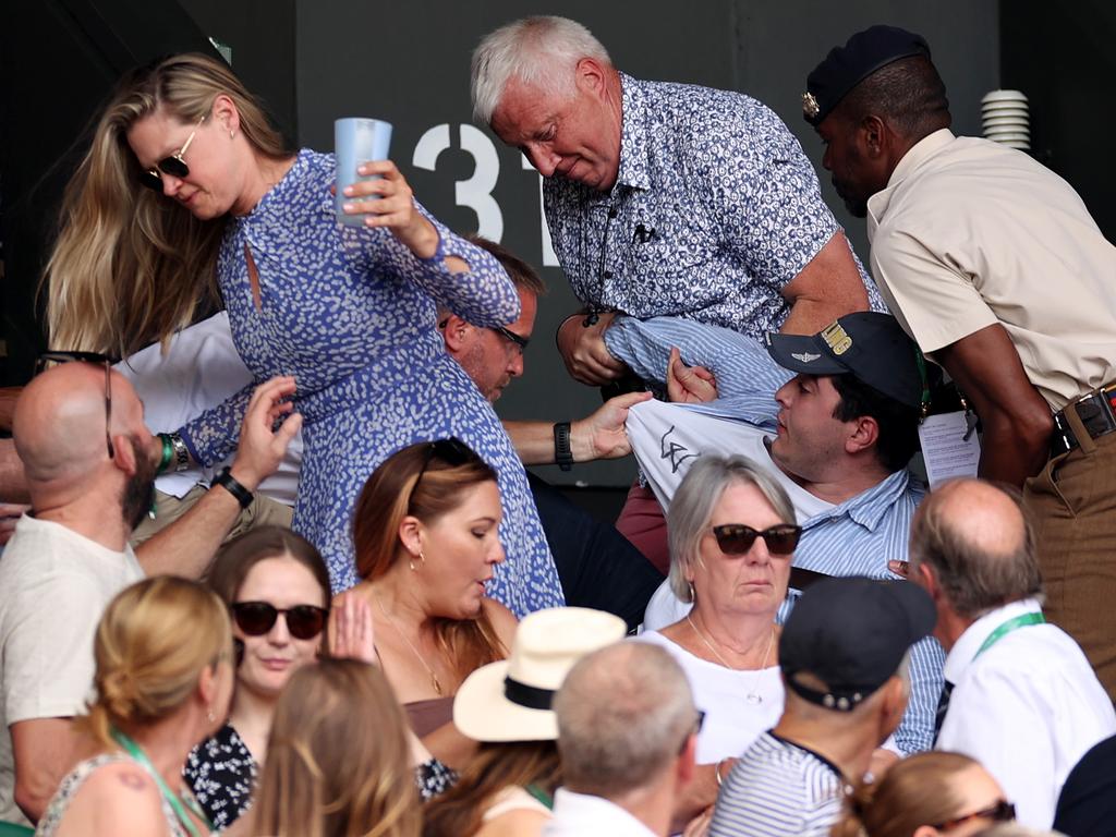 Security staff and spectators remove a protester from the stands during the Men's Singles Final match. Picture: Getty Images